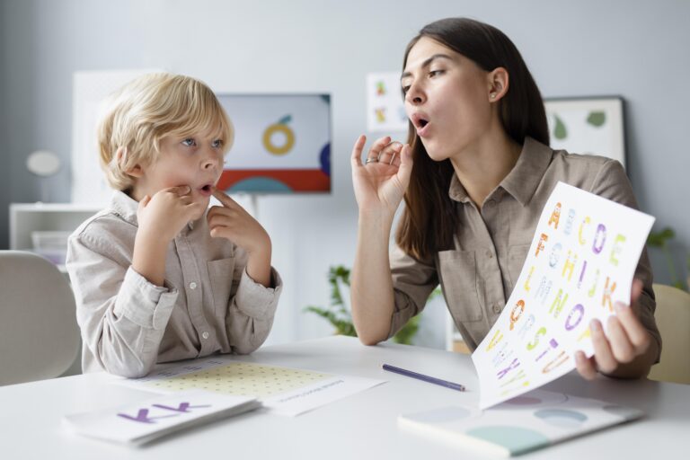 woman-doing-speech-therapy-with-little-blonde-boy